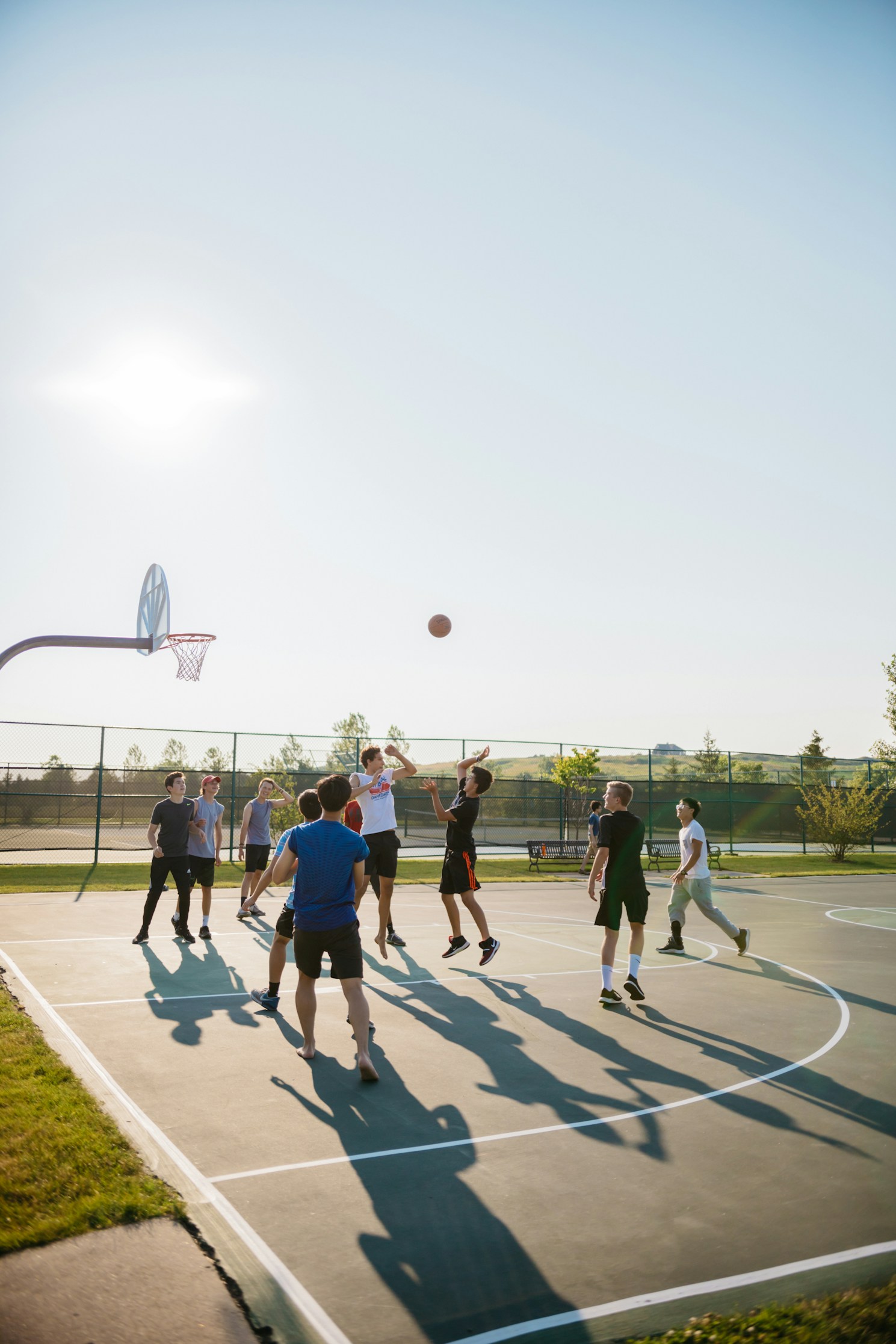 Group of people playing basketball on an outdoor court