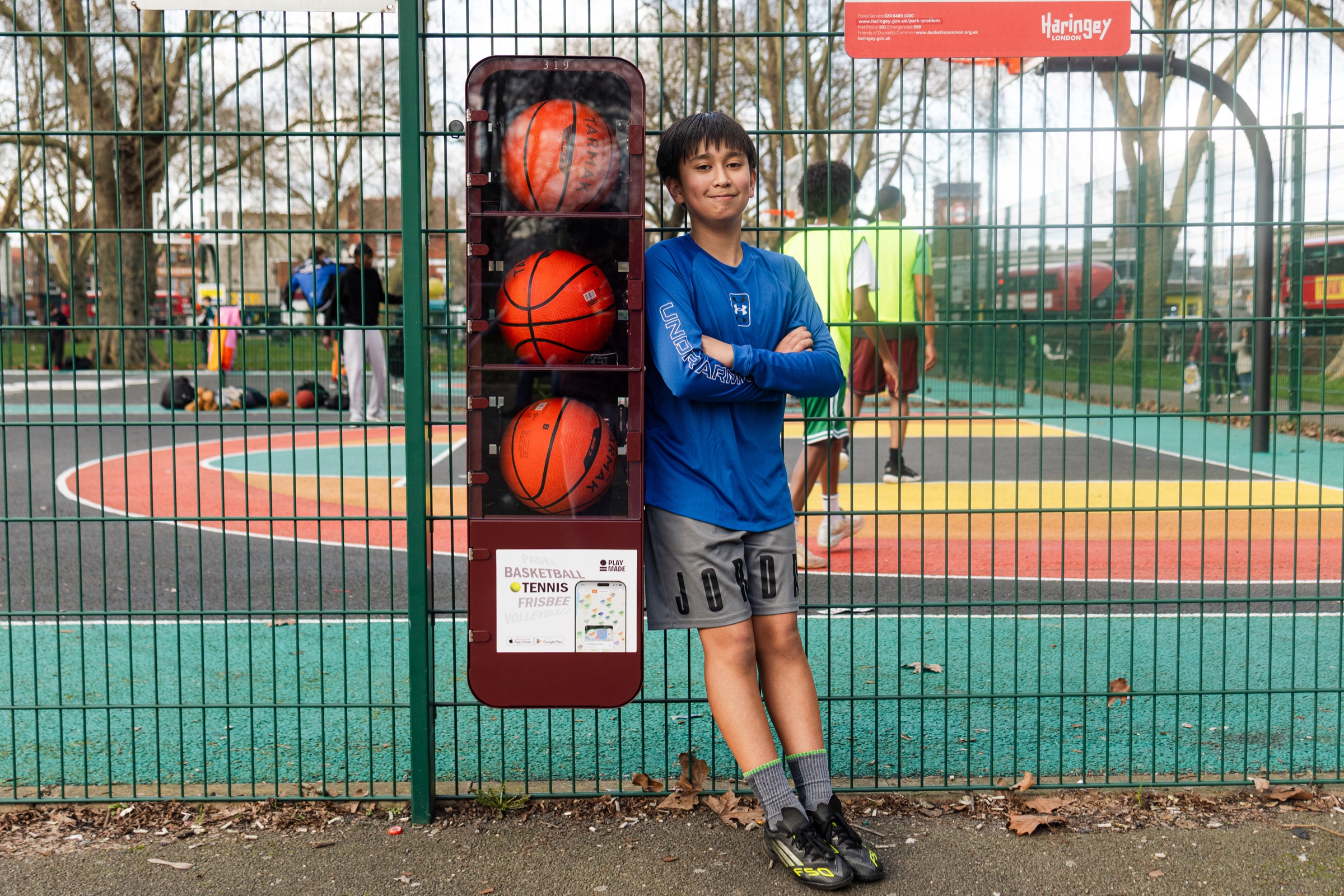 Urban court with player shooting a basketball and PlayMade equipment pod